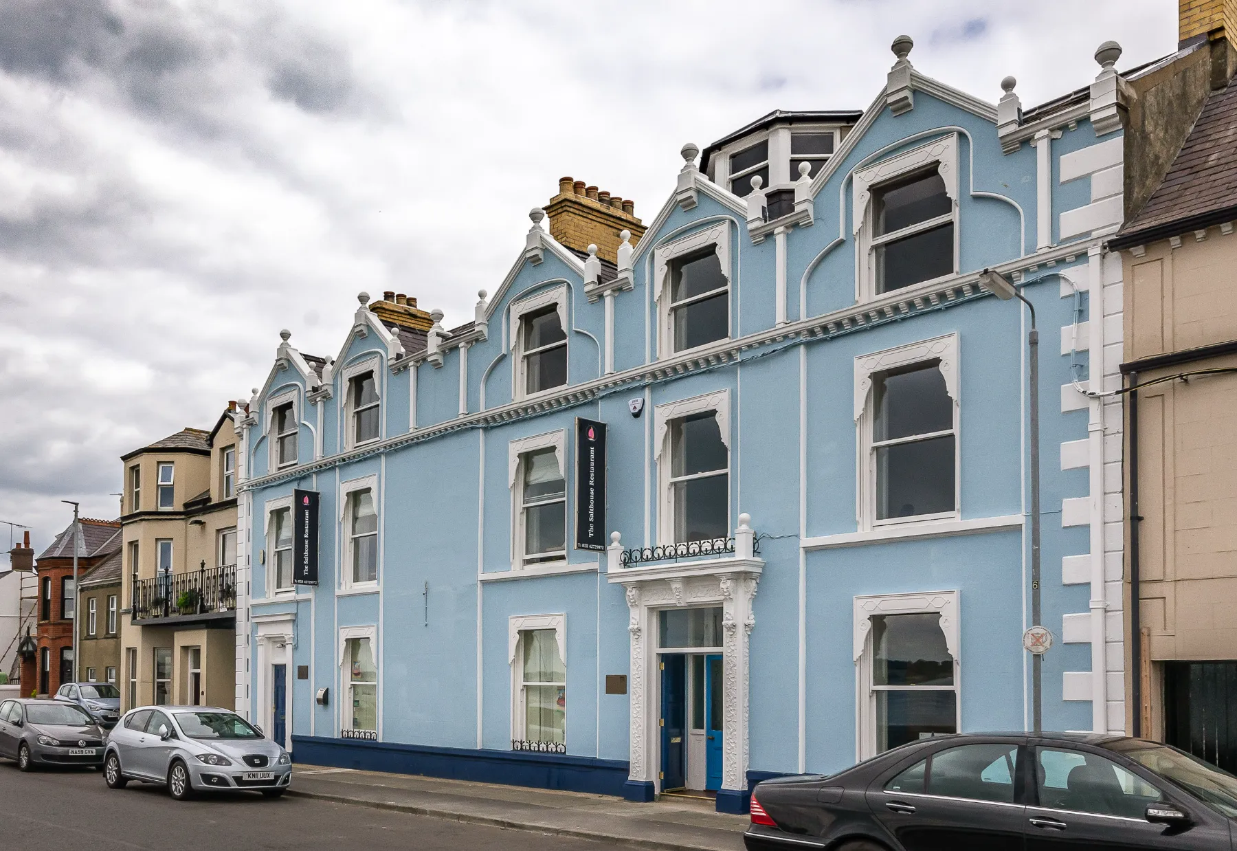 The pale blue Victorian frontage of Portaferry Sailing Club, home to The Salthouse Restaurant, on the Portaferry shorefront